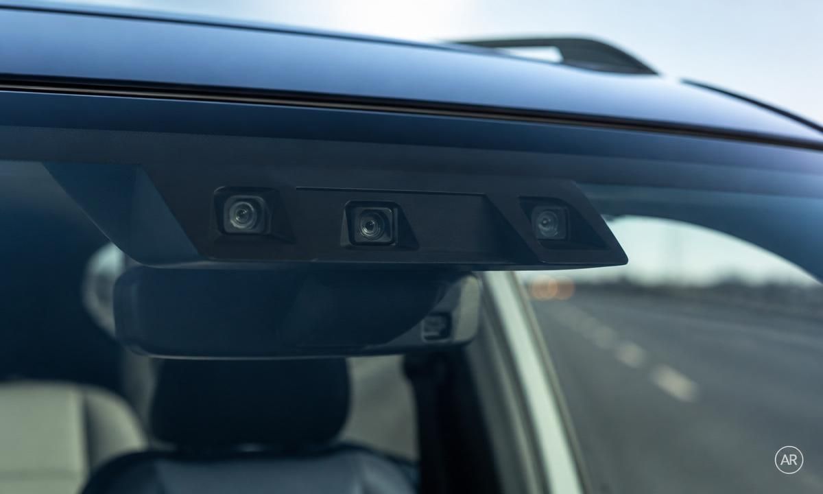 2026 Subaru Outback triple-camera EyeSight sensor mounted behind the windshield, viewed from the cabin