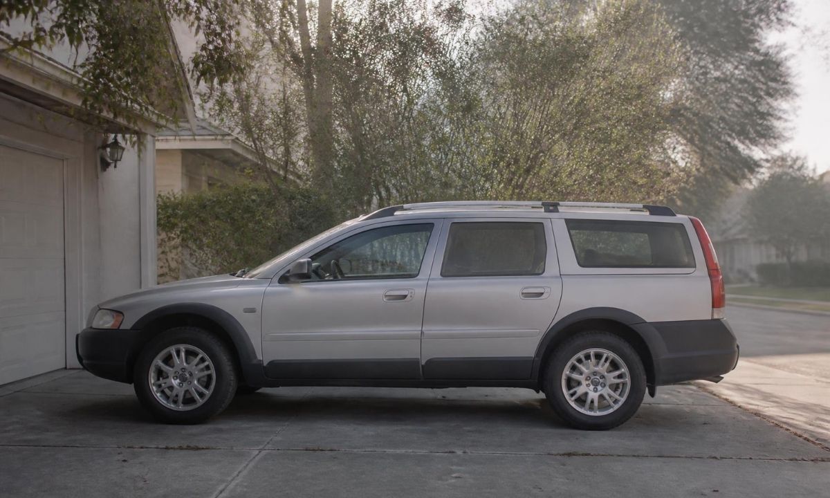 Silver Subaru Outback wagon parked in a suburban driveway in morning light