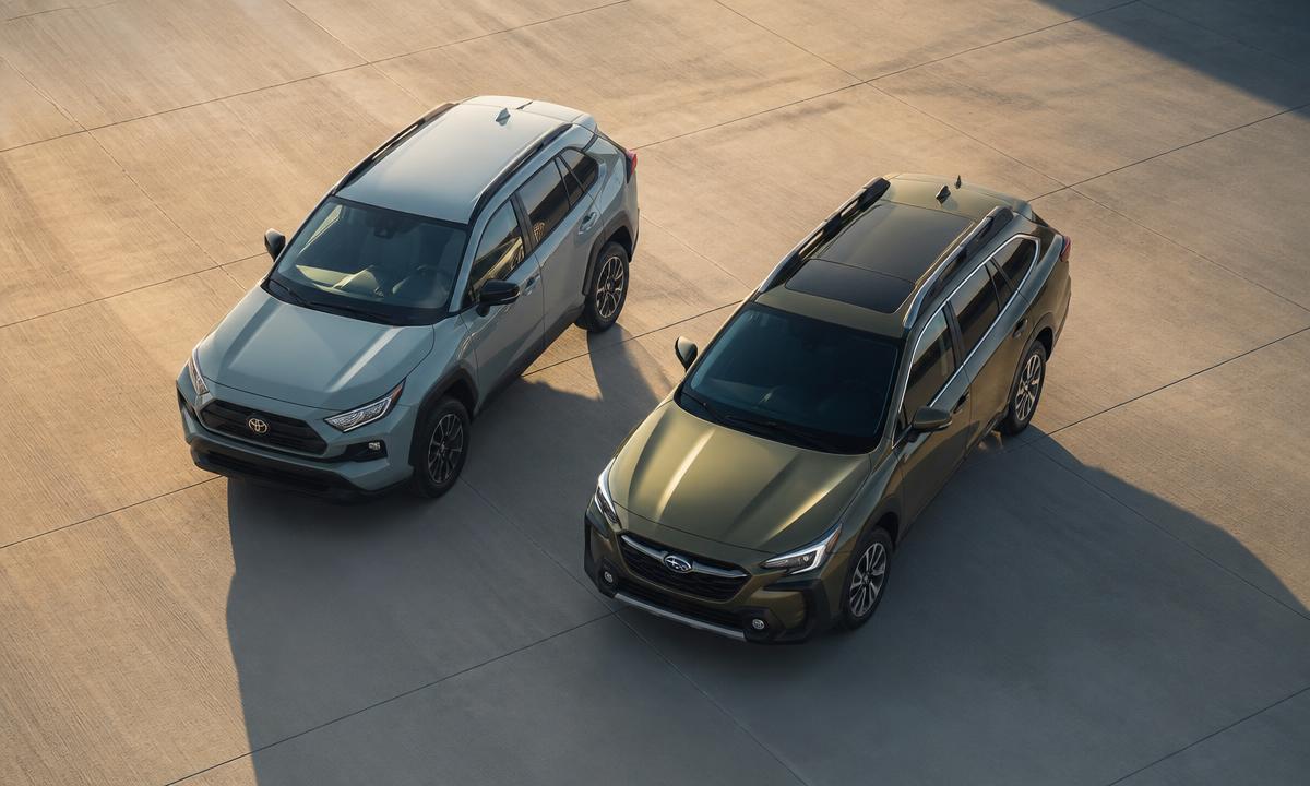 Toyota RAV4 and Subaru Outback photographed in profile side by side in open countryside