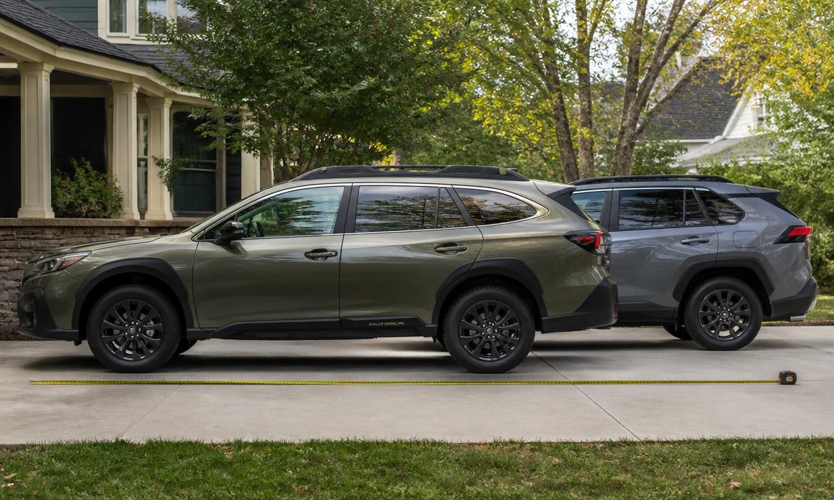 Subaru Outback and Toyota RAV4 measured side by side in a driveway to show length difference